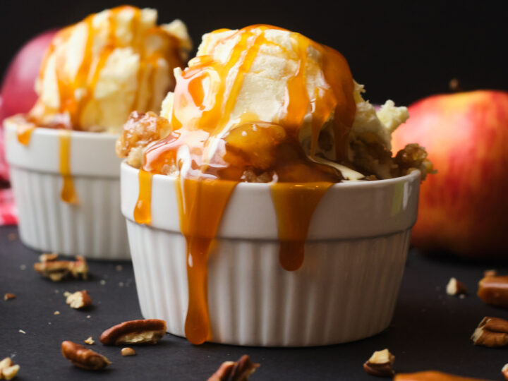caramel apple dump cake in a ramekin with caramel sauce dripping down