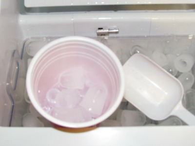 inside ice maker with cup