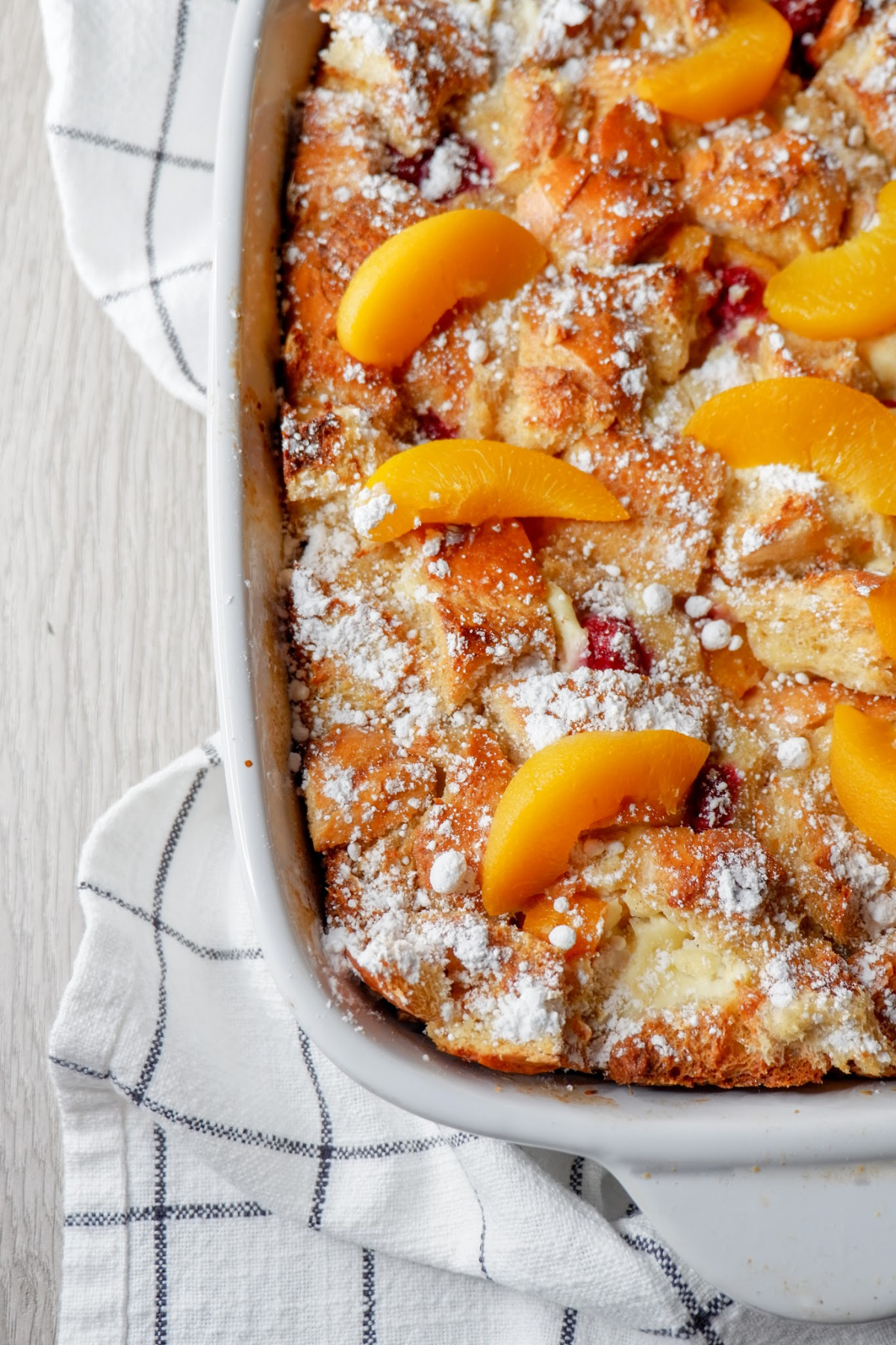 Dress up your french toast with this raspberry peach baked french toast recipe. A make-ahead dish that you can toss in the oven come morning, for a sweet breakfast. #makeahead #overnight #frenchtoast #frenchbread #recipe #casserole #easy #best #peach #raspberry