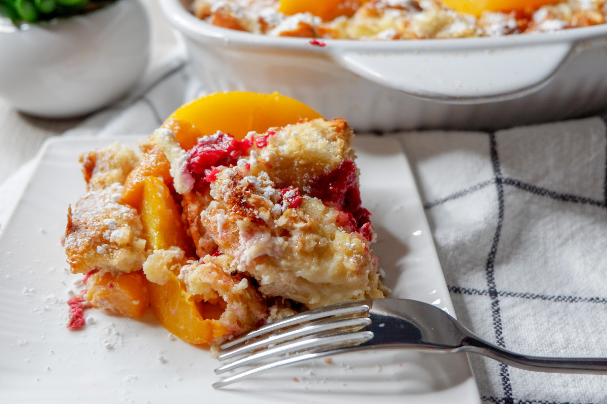 Whip up this raspberry peach baked french toast recipe the night before, so all you have to do is toss it in the oven to bake in the morning. An overnight french toast bake that is filled with fruit and tender french bread. #easy #best #frenchtoast #casserole #overnight #fruit #oven #brunch #holiday #breakfast