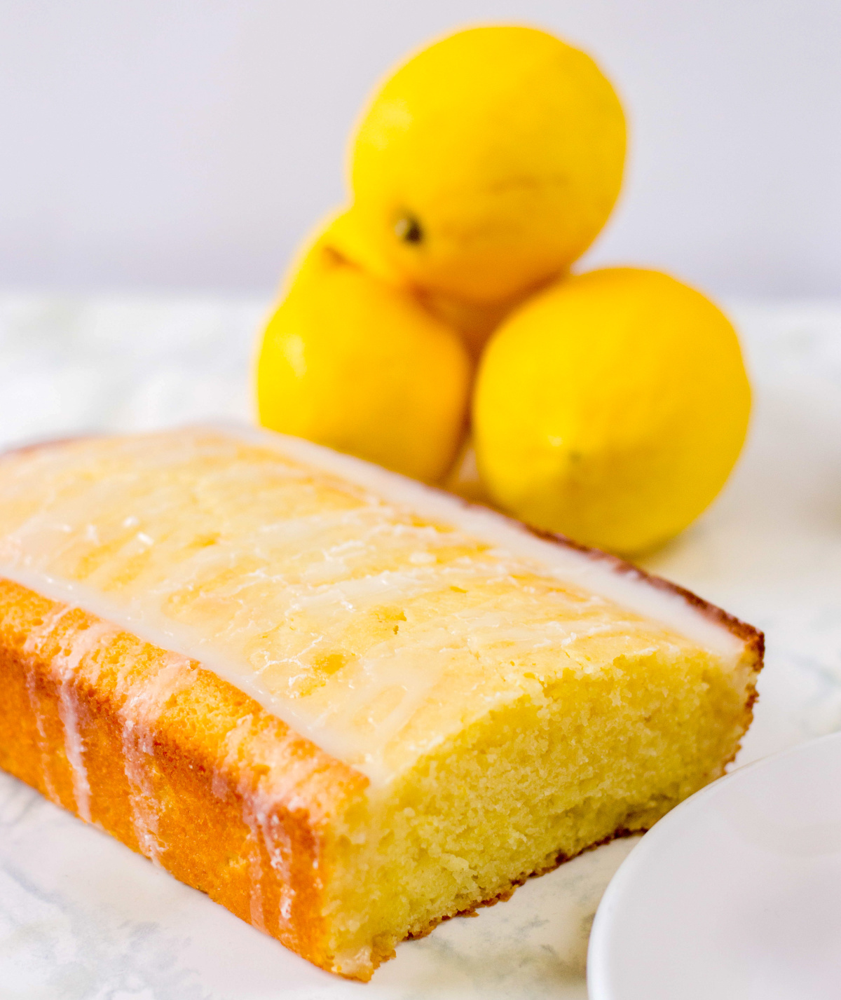 lemon loaf with lemons in the background