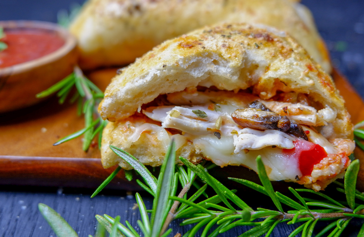 chicken calzone in half with chicken and melted cheese