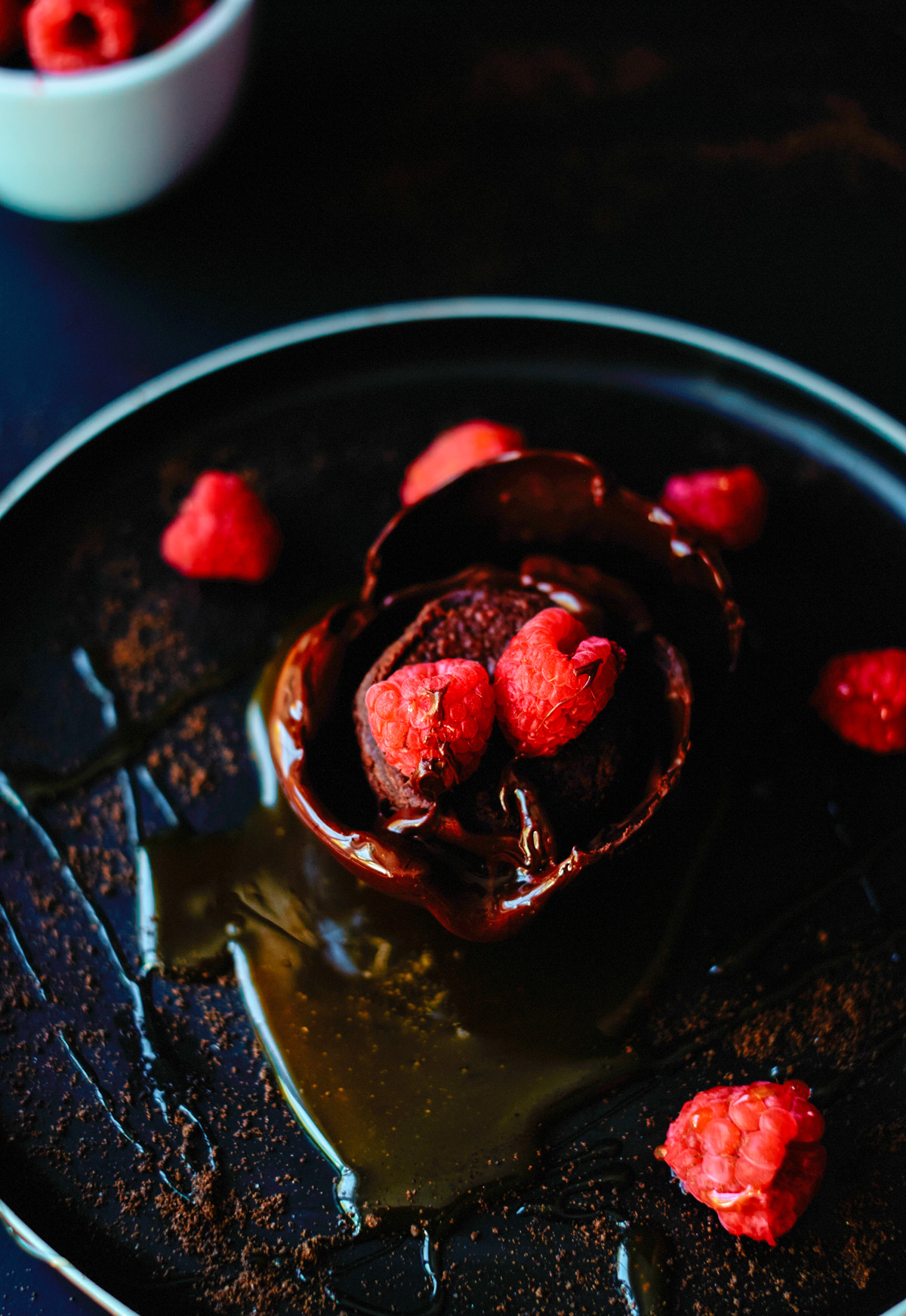 chocolate dessert with a brownie and raspberries and caramel