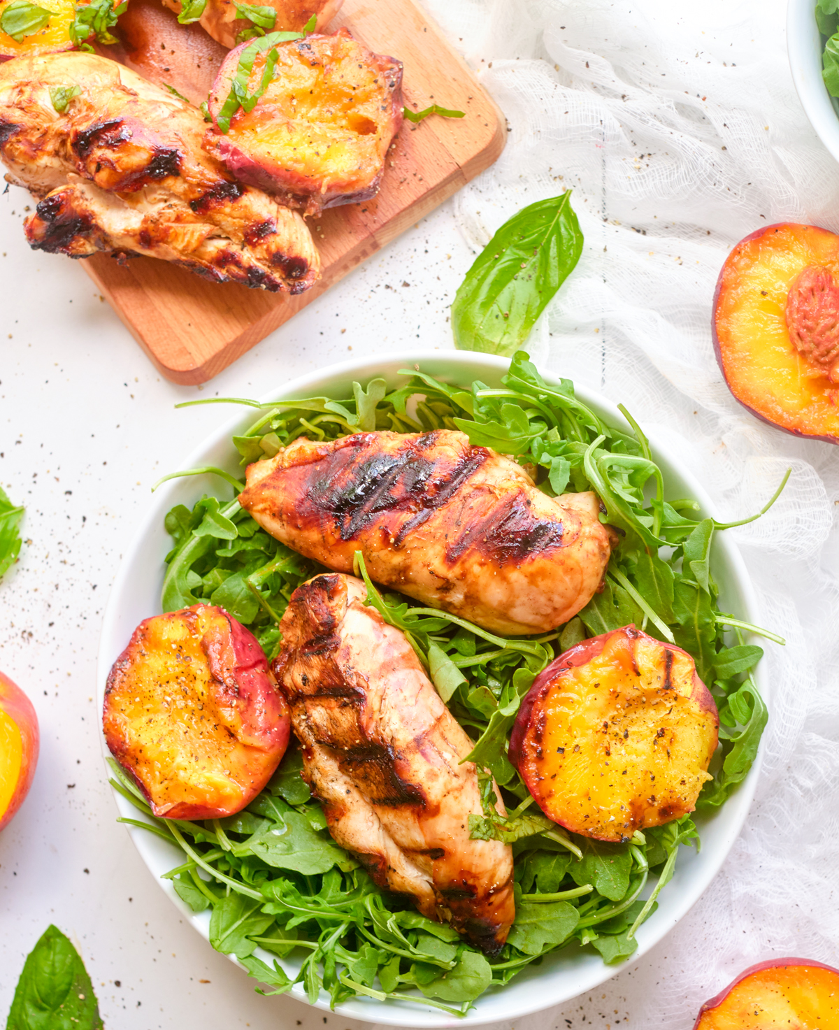 grilled balsamic chicken and peaches on arugula