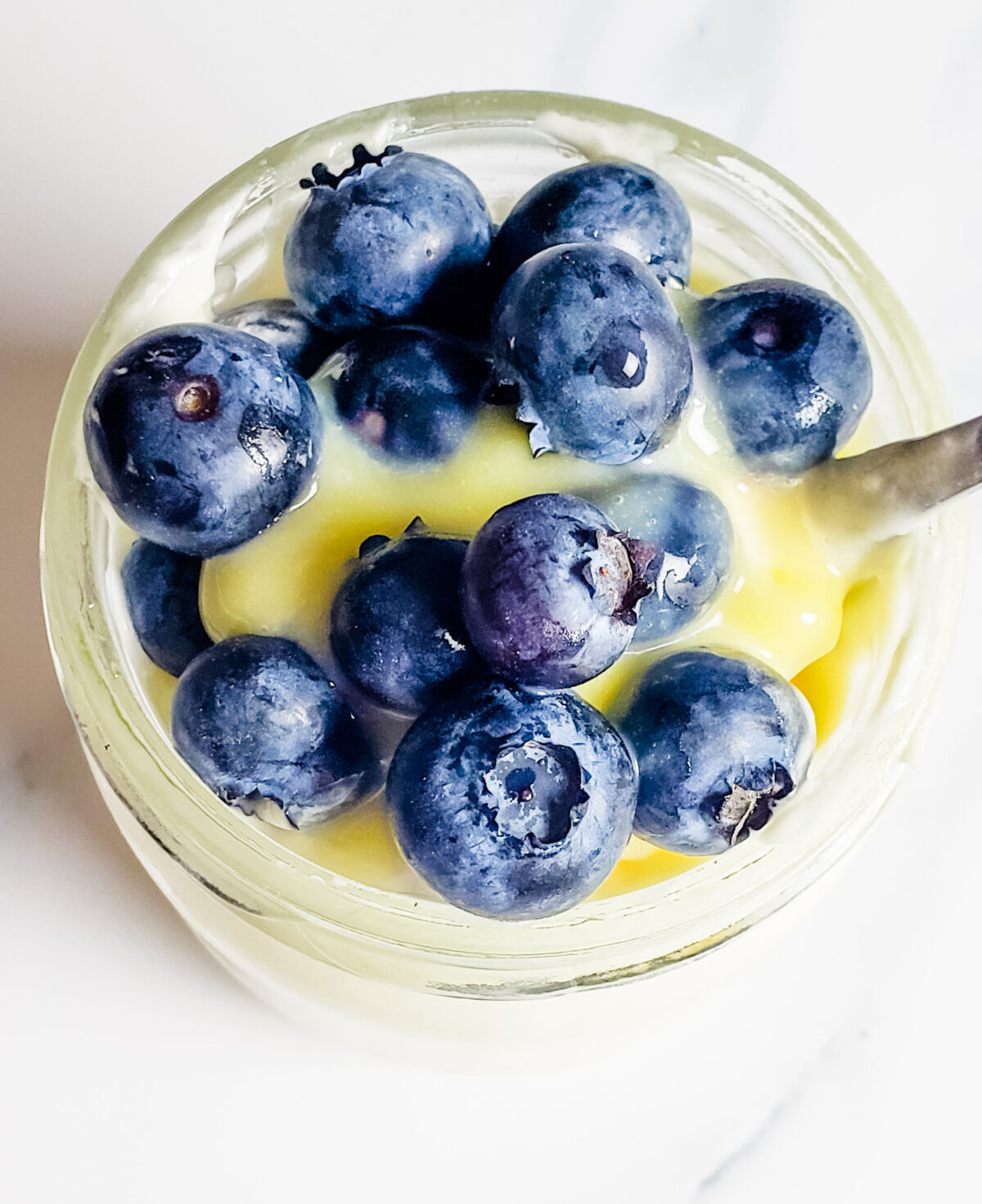 lemon mousse topped with blueberries in a mini jar