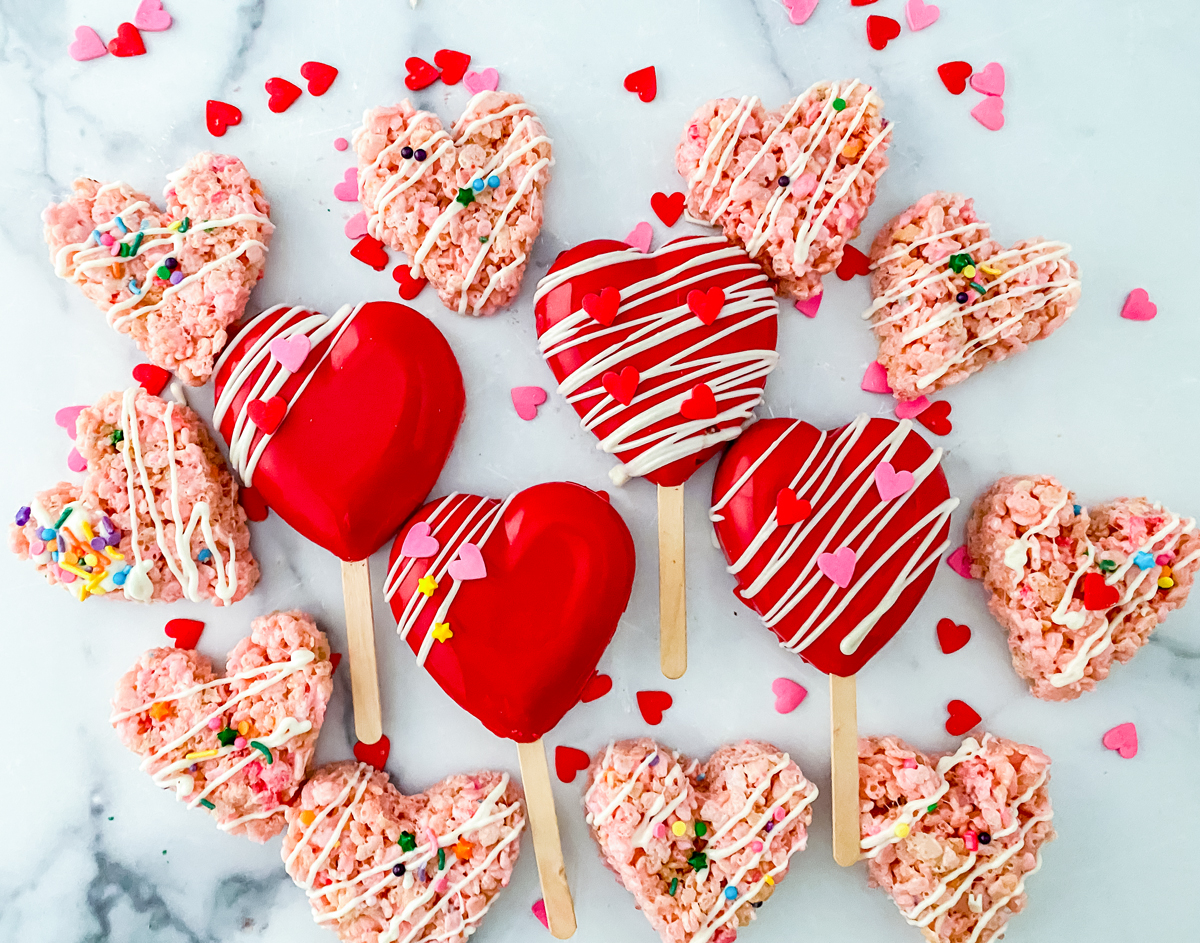 heart shaped rice krispies treats surrounding 4 red chocolate covered heart shaped rice krispies pops