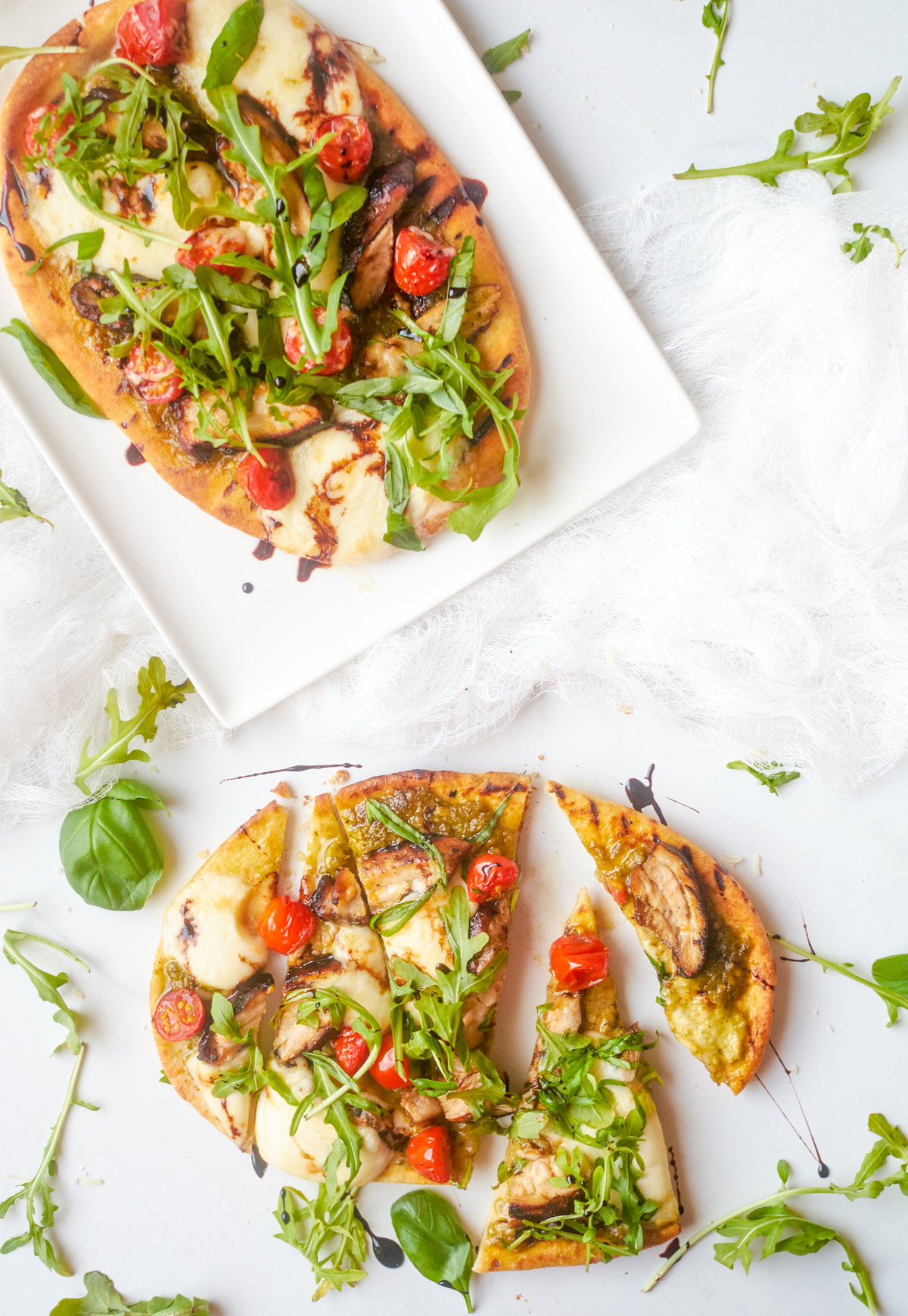 2 chicken caprese flatbread pizzas one whole and one sliced