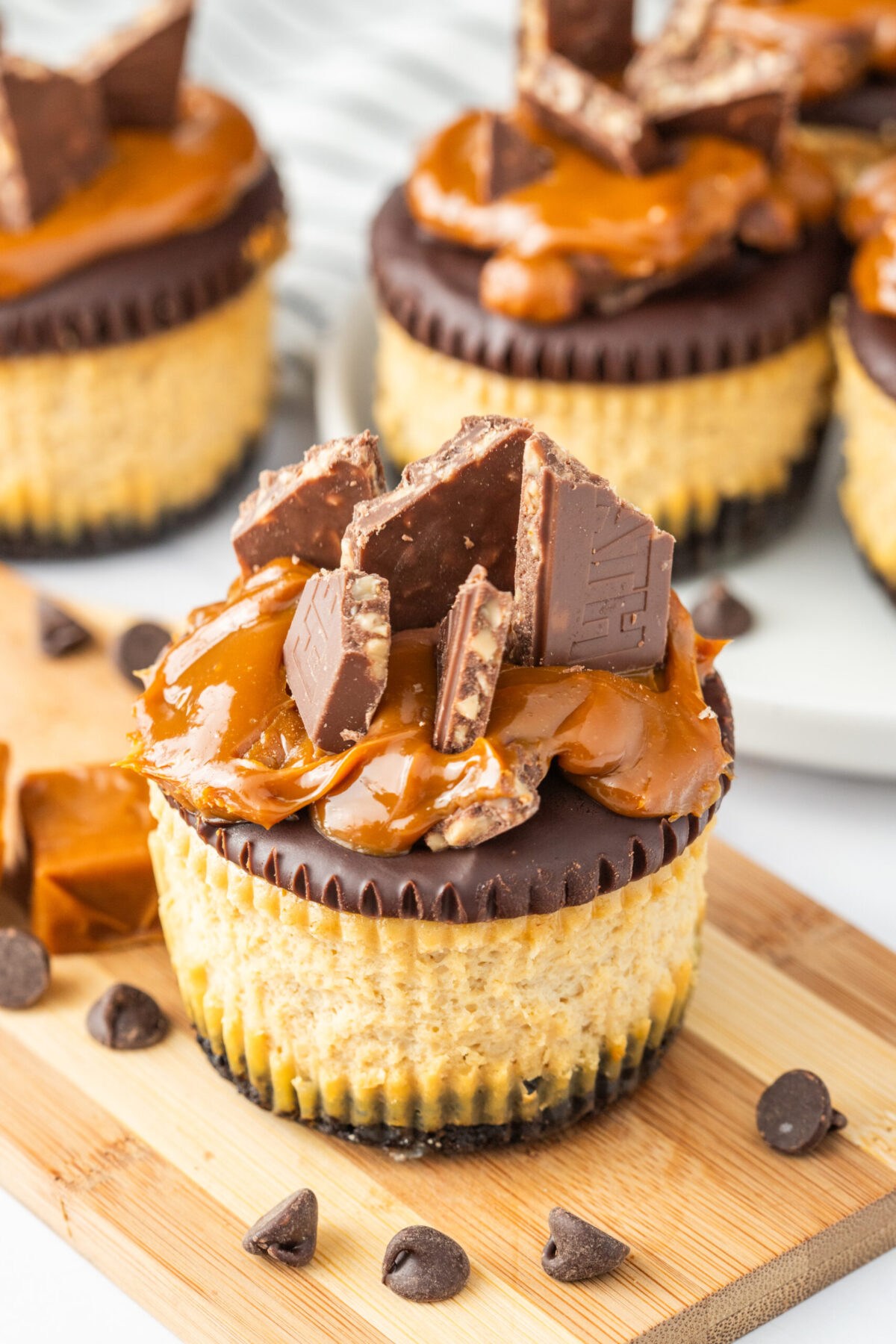 mini cheesecakes on a wood board.